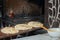 Before baking in the oven, the chef sprinkles the buns with sesame seeds. Buns for making traditional duner Tombik Doner,