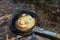 Baking pancakes on a fire.