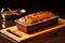 Baking perfection, steel tray holds homemade banana bread wooden board