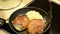 Baking potato pancakes. hand turn upside pancakes and close pan