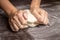 Baking preparing background. Female hands kneading dough