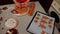 Baking sheet with cut out gingerbread cookies and confectioner kneading dough, preparing festive pastries for Christmas