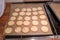 On  baking tray lie the ready baked light cookies