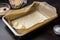 baking tray with parchment paper and pastry bag for piping cream filling