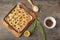 Baking tray with traditional Italian Focaccia on grey table