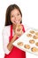 Baking woman eating cookies happy