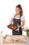 Baking woman showing a tray of cookies fresh out of the oven