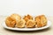 Baklava made of thin dough with chopped nuts and honey syrup on the table on a light background