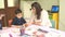 Baku, Azerbaijan-March 15, 2019: Female infant school teacher reading a book to children sitting on chairs in a classroom, close u