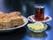 Baku pakhlava on a platter with tea poured into a glass of Armud and lemon