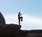 Balance is the key. A male kickboxer balancing on a cliff.