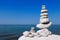 Balance and poise stones against the sea. White Rock zen on the background of blue sky.