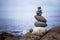 Balance, relaxation and wellness: Stone cairn outside, ocean in the blurry background