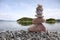 Balance stone on pile rock with river background.