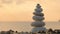 Balance stones on beach at sunset