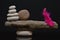 Balance with stones and red feather concept of harmony with zen rock