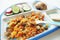 balanced baby food: stewed vegetables, fried chicken, chopped vegetables and bread rolls arranged in different sections on a plate