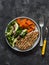 Balanced diet lunch - grilled turkey, boiled sweet potatoes, kale cabbage, avocado, cucumbers, radish salad on a dark background,