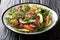 Balanced dietary salad of red fish, avocado, radish and a mix of micro green close-up on the table. horizontal