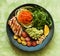 Balanced food concept. Buddha bowl salad with grilled chicken breast, arugula, avocado, carrots and zucchini, balanced clean eatin