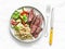 Balanced lunch - medium roast steak, vegetable salad and bulgur on a light background, top view