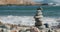 Balanced pebble pyramid on the beach