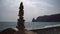 Balanced pebble pyramid on the beach on cloudy day. Abstract Sea bokeh on the background. Selective focus. Zen stones on