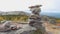 Balanced Rock Stones Stacked on Top of Each Other in the Mountain Valley. Hierarchy and Balance. Pyramid of Stones on