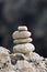 Balanced stacked stones or pebbles on a white sand beach