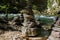 Balanced stacked of stones sculptures by Alpine river stream