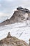 Balanced stone pyramid with Dachstein cable car station in background