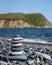 Balanced stone pyramide on the beach with black and grey stones