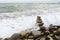 A balancing pyramid of rocks on the beach during a storm