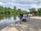 Balashikha, Moscow region, Russia, June, 23. 2020. People watching ducks in the Pekhorka river in sunny summer day. Moscow region,