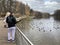 Balashikha, Moscow region, Russia, October, 23, 2019.  People watch ducks on the embankment of the Pekhorka river in the middle of