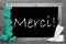 Balckboard With Turqouise Heart Decoration, Text Merci Means Thank You