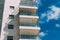 Balconies and blue sky with clouds. Part of a residential building in Israel.