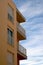 Balconies of buildings with blue sky background