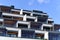 Balconies on a modern apartment building against the blue sky. Modern nordic architecture