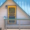 Balcony of an attic with yellow door and lamp