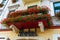 Balcony with beautiful red flowers and a signboard Hotel above t