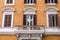 Balcony with columns and windows with shutters with marble ornaments in the old vintage house in Rome, capital of Italy