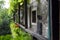 A balcony at a historic farmhouse in Trento, Italy. The balcony opens up the upper floor. Here are flower tubs and many items