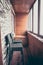 Balcony lodge interior in vintage nautical style decorated with wood planks and stone with big windows bar counter and bar chairs