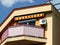 Balcony low angle view with canvas sunshade canopy in yellow and red