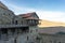 On the balcony of the monastery. Carved railings, balconies and stairs. Stone paths and walls. Tiled roof, blue sky and mountains