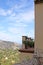 A balcony suspended between the mountains and the blue sky, in a small town in Sicily