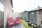 Balcony of a townhouse with two red armchairs and metal railings