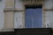 Balcony with two chairs. Low angle view on a balcony in a historical building with a modern French window.