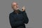 bald adult man pointing upwards ideal for advertising